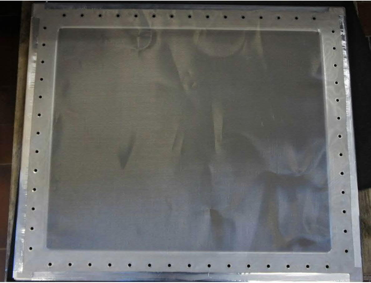 Conductive fabric sample mounted over the aperture of the shielded test room